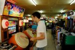 Playing on an arcade machine in an arcade on Insadong-gil, in Jongno-gu, Seoul, South Korea.